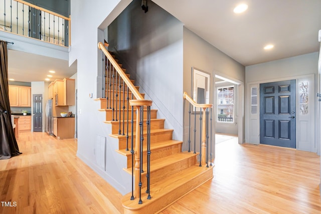 entryway featuring light wood finished floors, visible vents, stairway, and recessed lighting