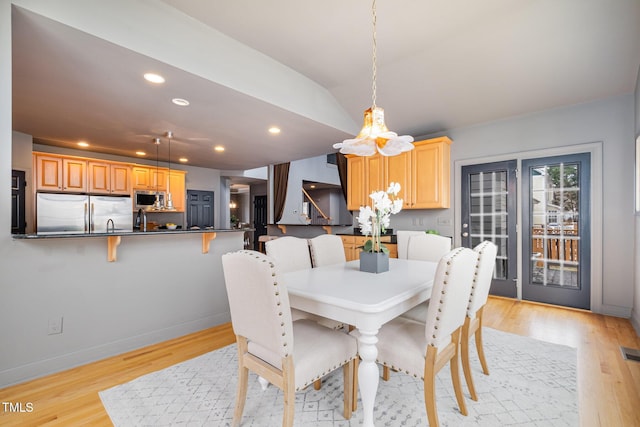 dining area with recessed lighting, visible vents, light wood-style flooring, vaulted ceiling, and baseboards