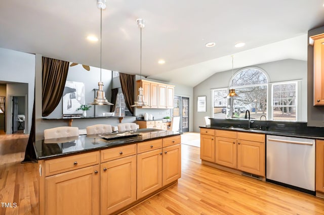 kitchen featuring a sink, light wood-style floors, vaulted ceiling, dishwasher, and pendant lighting