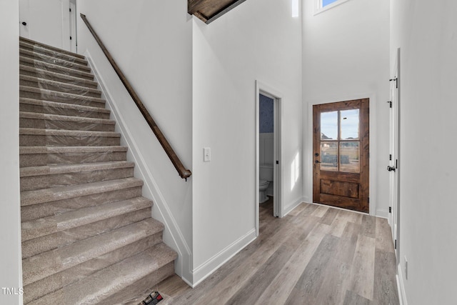 entrance foyer with a high ceiling and light wood-type flooring