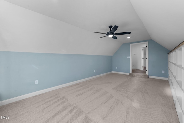 bonus room featuring ceiling fan, vaulted ceiling, and light colored carpet