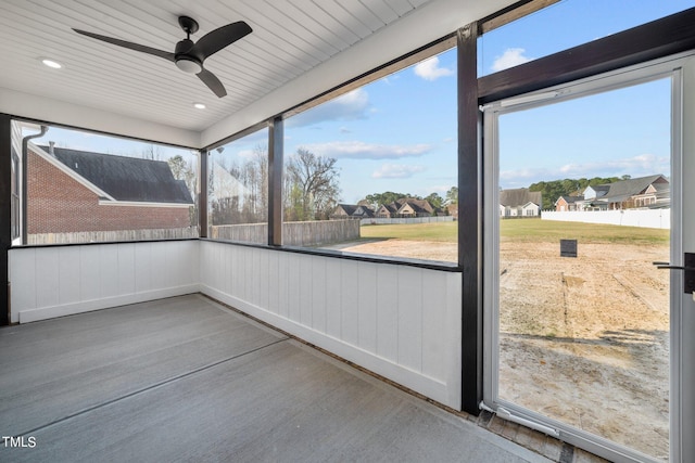 unfurnished sunroom featuring ceiling fan