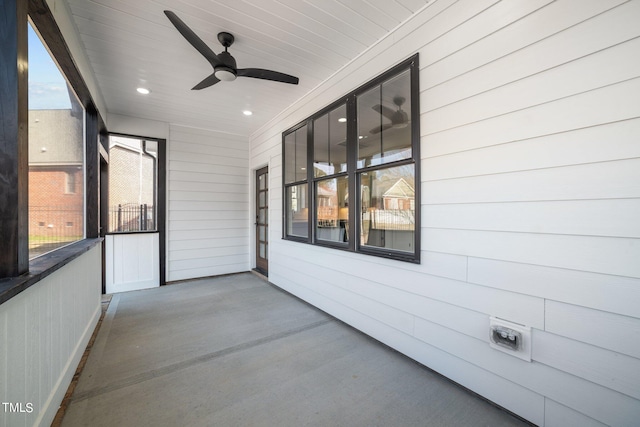 unfurnished sunroom featuring ceiling fan and plenty of natural light