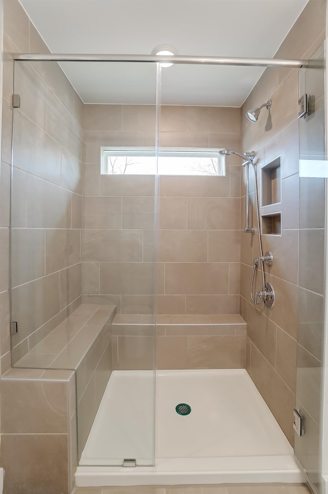 bathroom with an enclosed shower and a wealth of natural light