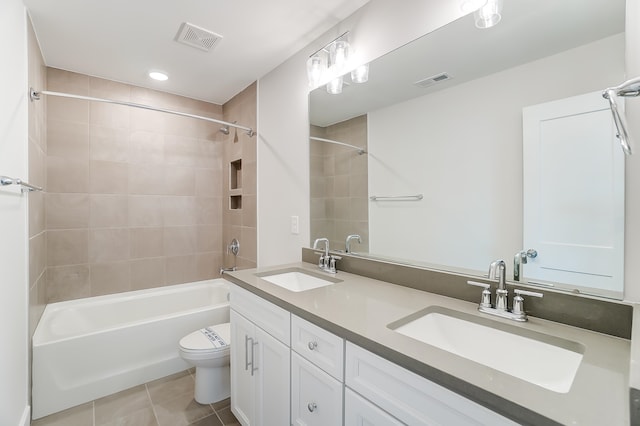 full bathroom with vanity, tiled shower / bath combo, toilet, and tile patterned flooring