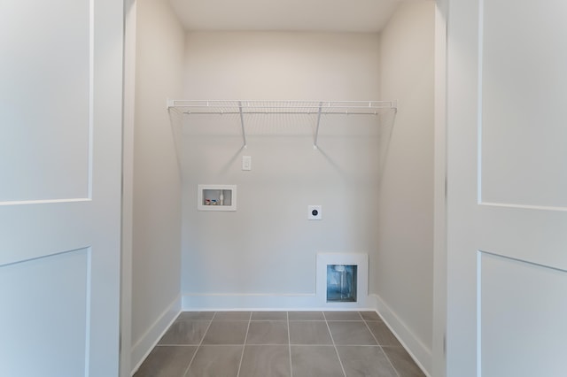 laundry room with hookup for a washing machine, electric dryer hookup, and dark tile patterned floors