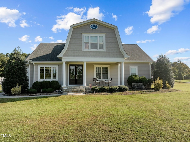 view of front of home with a porch and a front yard