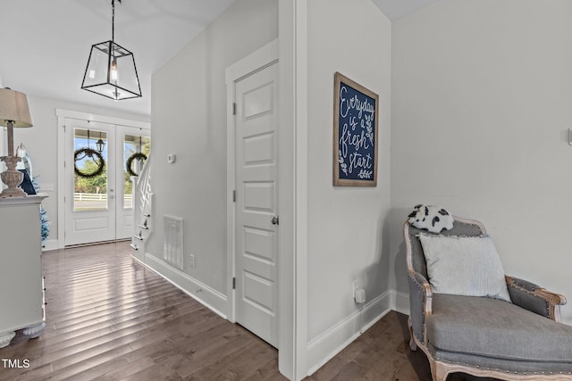 foyer with french doors and dark hardwood / wood-style flooring