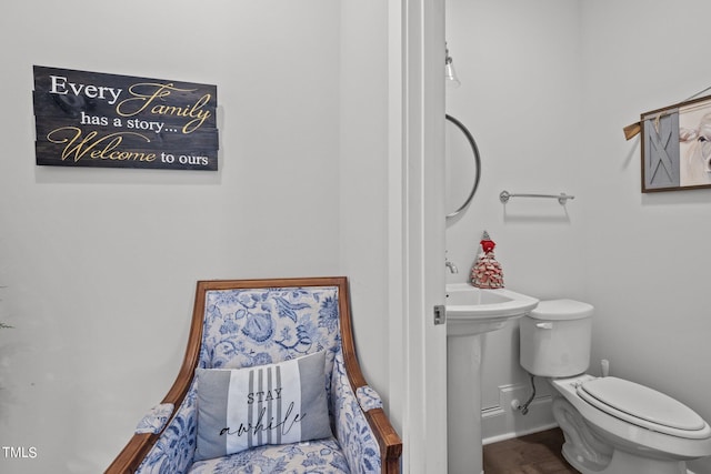 bathroom featuring toilet and wood-type flooring