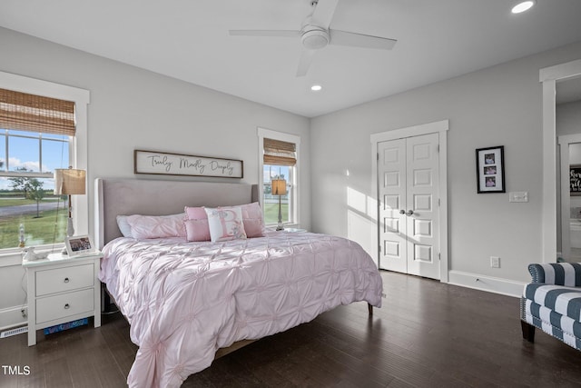 bedroom with dark hardwood / wood-style flooring and ceiling fan