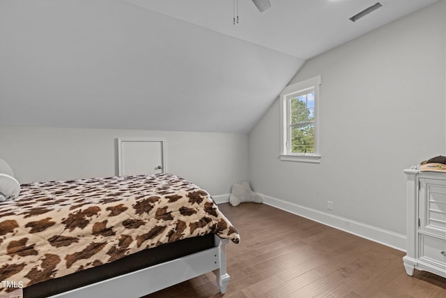 bedroom with lofted ceiling, hardwood / wood-style floors, and ceiling fan