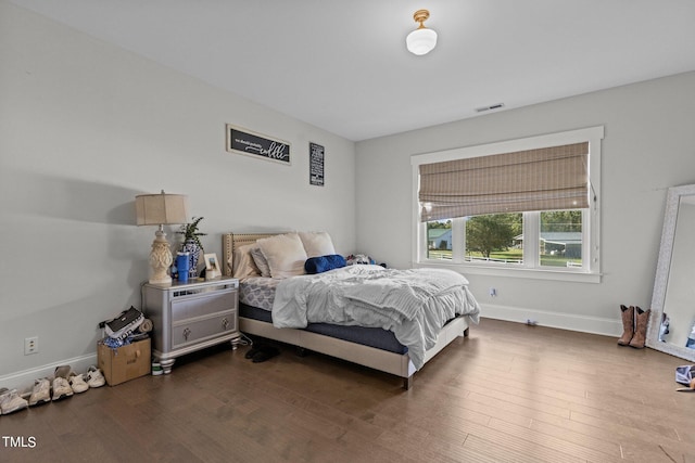 bedroom with dark wood-type flooring