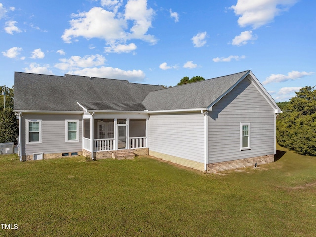 rear view of house featuring a yard