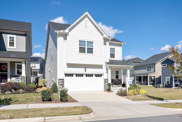 view of front of house featuring a front lawn and a garage