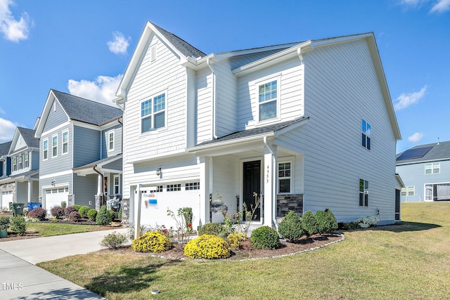 view of front of home with a front lawn and a garage