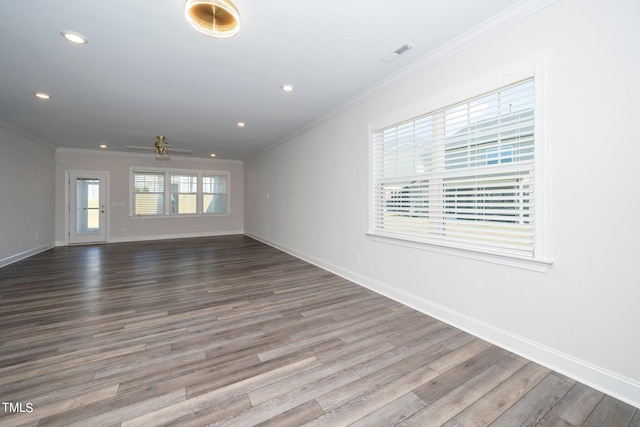 empty room with ornamental molding, hardwood / wood-style flooring, and ceiling fan