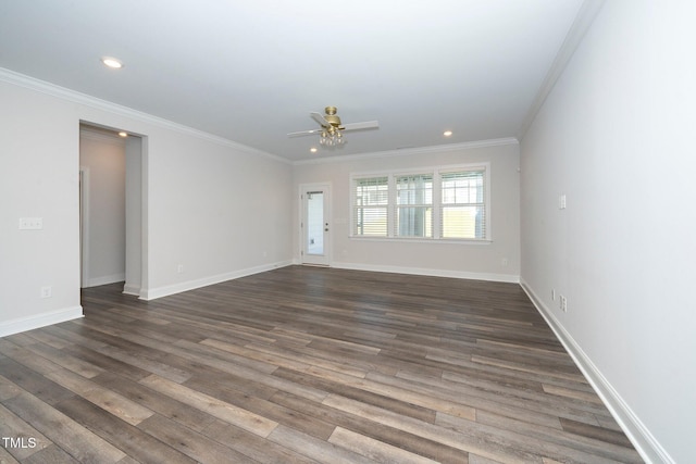 spare room featuring ornamental molding, ceiling fan, and dark wood-type flooring