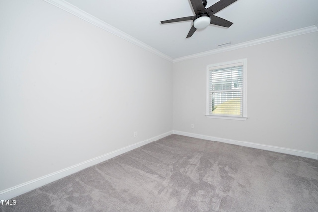 carpeted spare room featuring crown molding and ceiling fan