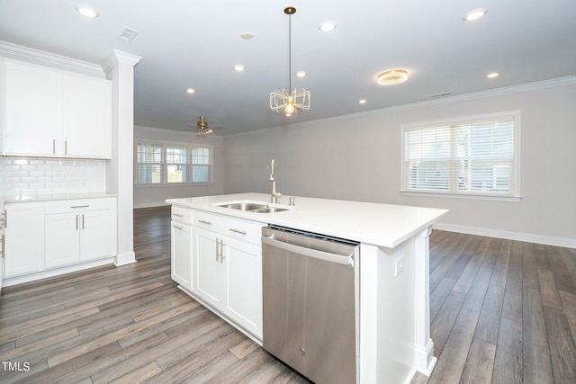 kitchen featuring white cabinets, decorative light fixtures, sink, and dishwasher