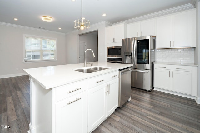 kitchen with an island with sink, sink, white cabinetry, stainless steel appliances, and dark hardwood / wood-style flooring