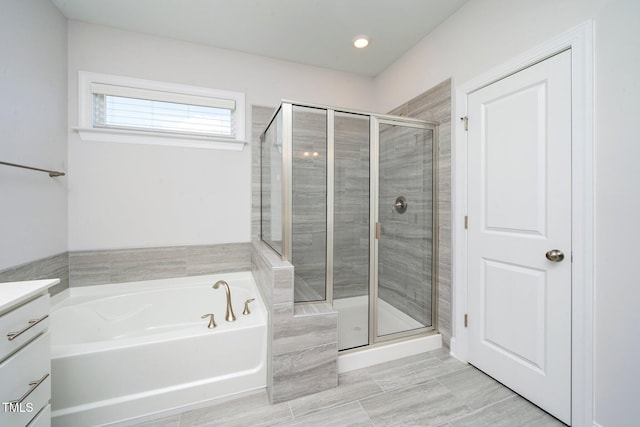 bathroom with separate shower and tub and vanity