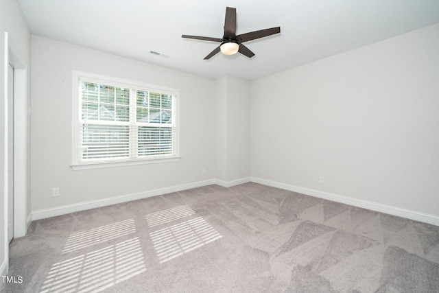 unfurnished room featuring ceiling fan and light carpet