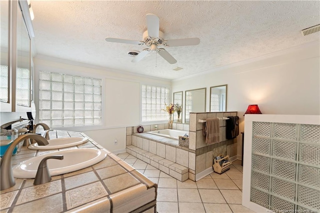 bedroom with light tile patterned flooring, ceiling fan, crown molding, and a textured ceiling