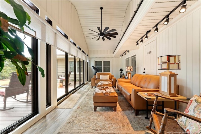 interior space with track lighting, lofted ceiling, and ceiling fan