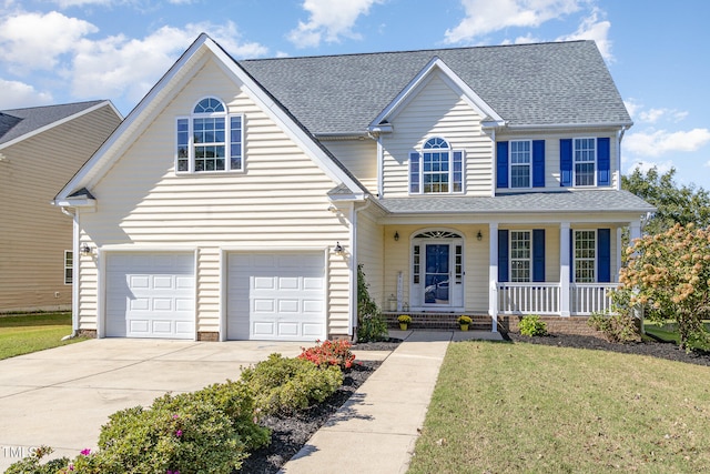 view of front facade featuring a front yard, a garage, and a porch