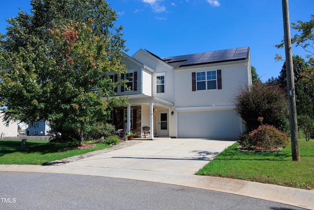 view of front facade featuring a front lawn, solar panels, a porch, and a garage