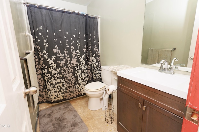 bathroom with toilet, tile patterned flooring, and vanity