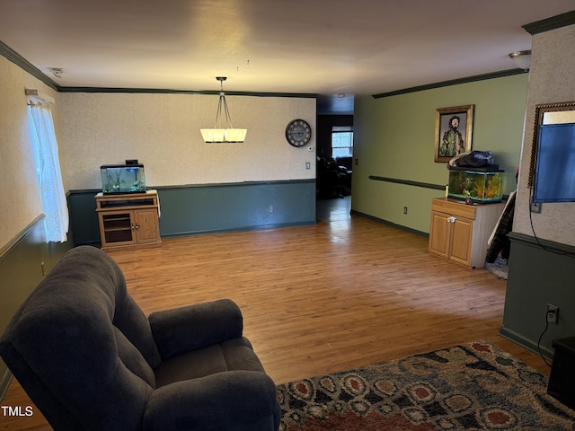 living room featuring wood-type flooring and crown molding