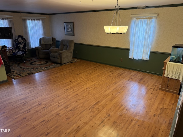 living room featuring hardwood / wood-style flooring and ornamental molding