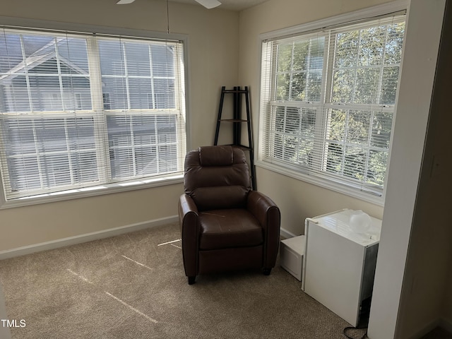 sitting room with carpet floors and ceiling fan