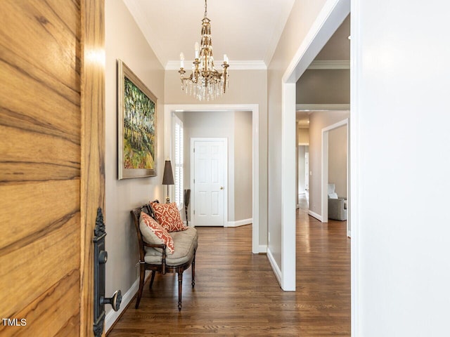 corridor featuring dark wood-type flooring, a notable chandelier, and ornamental molding