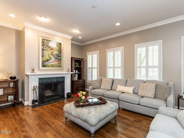 living room featuring crown molding, a high end fireplace, and dark hardwood / wood-style floors