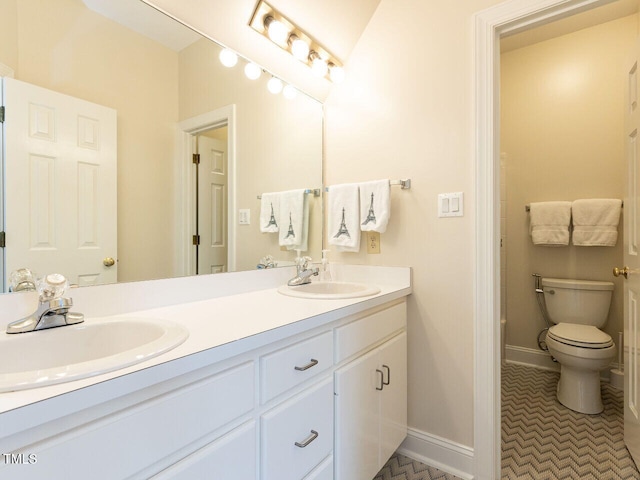 bathroom featuring tile patterned flooring, vanity, and toilet