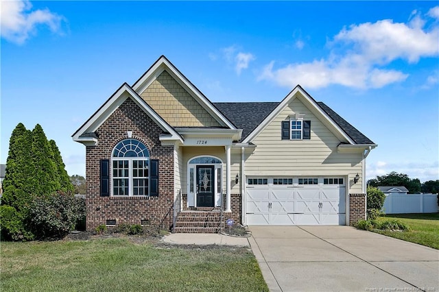 craftsman house featuring a garage, brick siding, fence, driveway, and crawl space