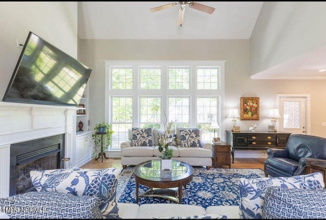 living room with ceiling fan, wood-type flooring, vaulted ceiling, and a wealth of natural light