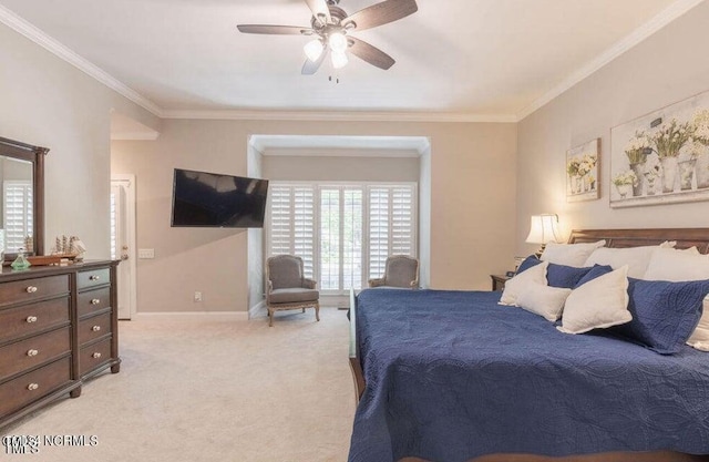 bedroom with ornamental molding, light carpet, multiple windows, baseboards, and a ceiling fan