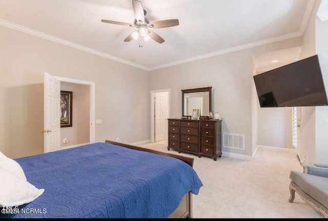 carpeted bedroom featuring ornamental molding, baseboards, and a ceiling fan