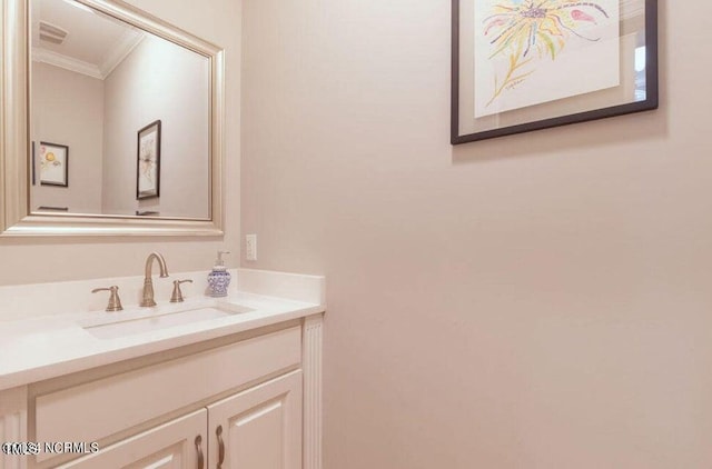 bathroom featuring crown molding and vanity