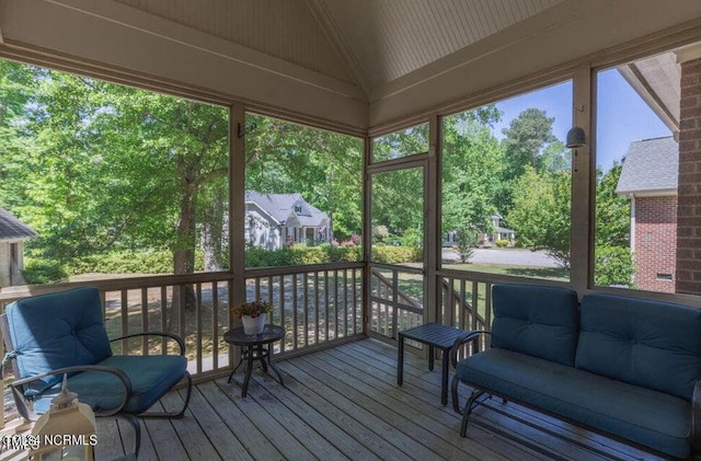 sunroom featuring a wealth of natural light and vaulted ceiling