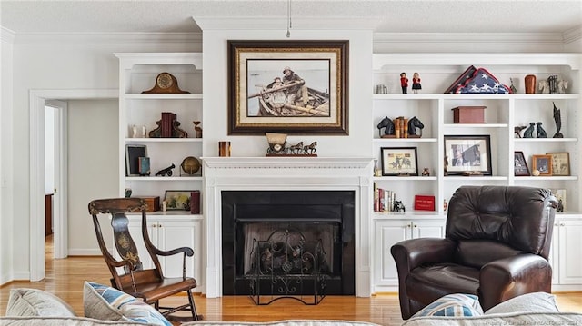 living area with light hardwood / wood-style floors and crown molding