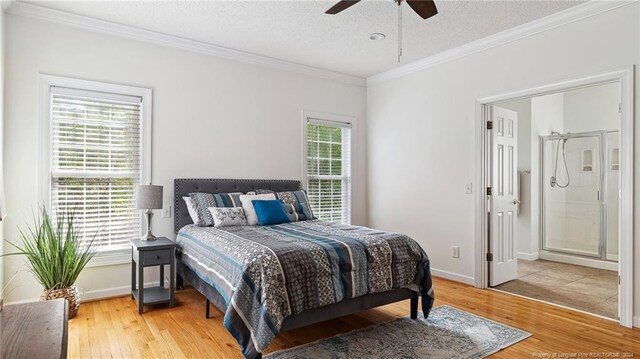 bedroom featuring a textured ceiling, multiple windows, and hardwood / wood-style floors