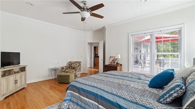 bedroom featuring ornamental molding, a textured ceiling, wood-type flooring, and ceiling fan