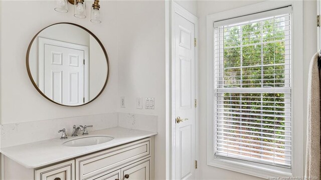 bathroom featuring a wealth of natural light and vanity