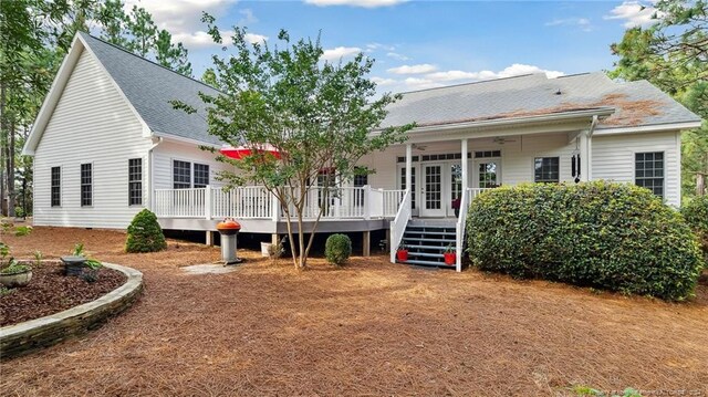 back of property featuring ceiling fan and a deck