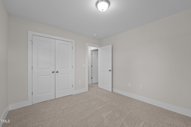 unfurnished bedroom with carpet flooring and a closet