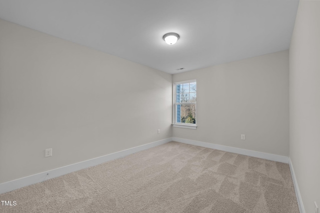 unfurnished room featuring light carpet